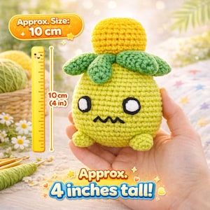 May include: A handmade crochet plush toy in the shape of a yellow fruit with green leaves and a yellow top. The toy has black eyes and a zig-zag mouth. It is approximately 4 inches tall.