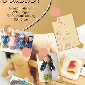 May include: A book titled "Creatisbuch" with a heart-shaped design on the cover. The book includes sewing patterns and instructions for making doll clothes for dolls 30-40 cm tall. The book cover features images of dolls wearing different outfits.