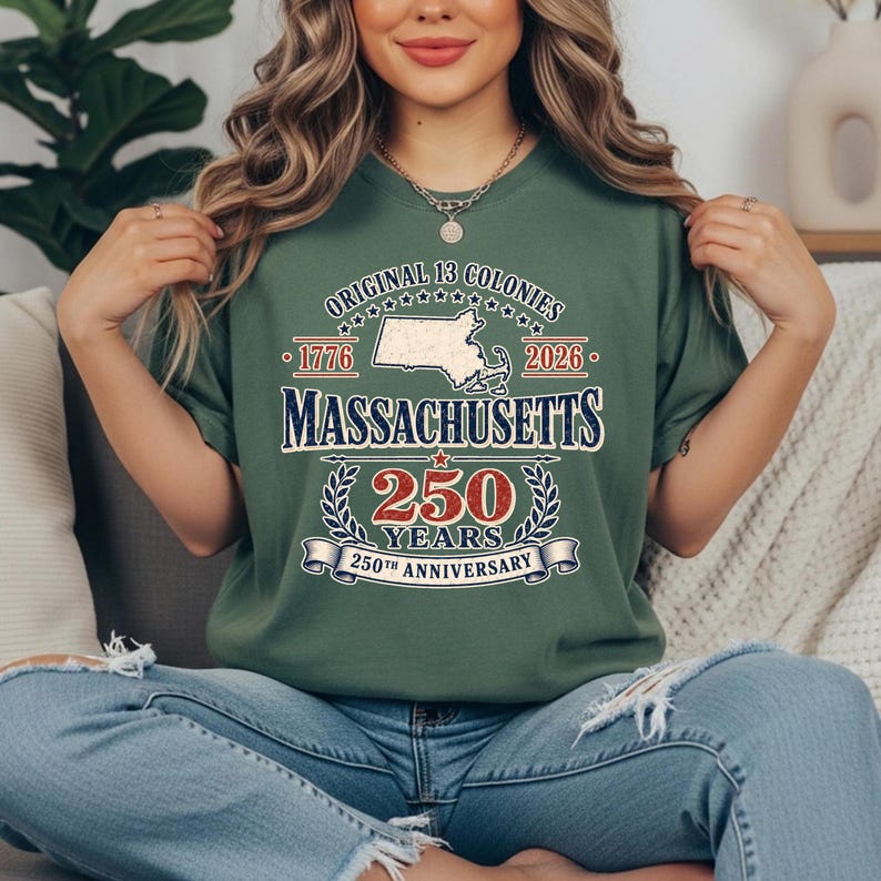 May include: Green t-shirt with the text "Original 13 Colonies" and "Massachusetts 250 Years 250th Anniversary". The design includes a map of Massachusetts, the years 1776 and 2026, and a banner.
