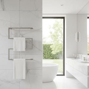 May include: A modern bathroom with white marble tile and a stainless steel towel warmer. Two white towels hang on the warmer. A white bathtub and vanity are visible in the background, with a large window overlooking greenery.