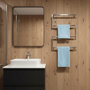 May include: A modern bathroom scene featuring a black-framed mirror, a white rectangular sink atop a black cabinet, and a stainless steel towel rack with two light blue towels. The background is wooden paneling.