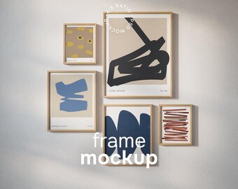 May include: A set of framed art prints featuring abstract designs in shades of blue, black, and brown. The frames are a light wood colour, and the arrangement is displayed on a white wall. The text "frame mockup" is visible.