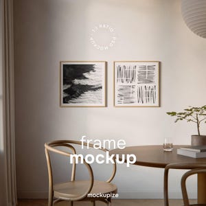 May include: Two framed art prints with abstract black and white designs hang on a cream-coloured wall. The frames are light wood. A wooden chair and table are in the foreground. The text "frame mockup" and "mockupize" are visible.