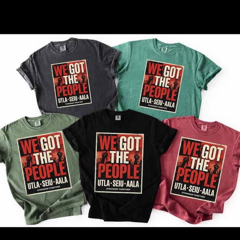 May include: Five t-shirts in various colors: charcoal, teal, olive green, black, and burgundy. Each shirt features a rectangular graphic with the text "WE GOT THE PEOPLE" in red and white, with the text "UTLA-SEIU-AALA" below. The phrase "STRONGER TOGETHER" is at the bottom.