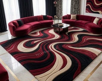 May include: A large rectangular area rug featuring a three-dimensional wave pattern in shades of deep red, black, and cream. The rug has a textured, carved surface with flowing, curved lines that create a sense of depth across the entire floor covering.