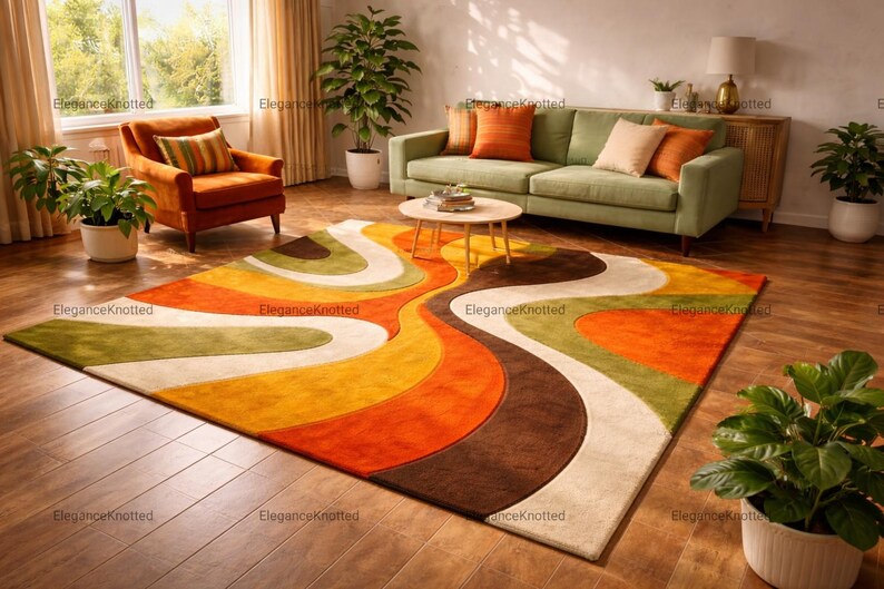 May include: A colorful, retro-style area rug with a wavy pattern in shades of orange, brown, yellow, and green. The rug is placed on a hardwood floor, and is surrounded by furniture and plants.
