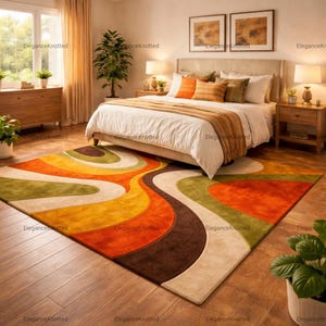 May include: A bedroom with a large, colorful rug featuring a retro wave design in shades of orange, brown, yellow, green, and cream. The room includes a bed with white bedding, wooden nightstands, and a dresser. Two framed pictures hang above the bed.