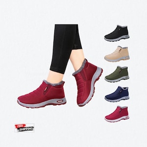 May include: Ankle boots with a quilted upper, a gray textured sole, and a plush gray lining. The boots are shown in maroon, black, beige, olive green, and navy blue. Each boot features a small side tag with the word FASHION on the heel area.