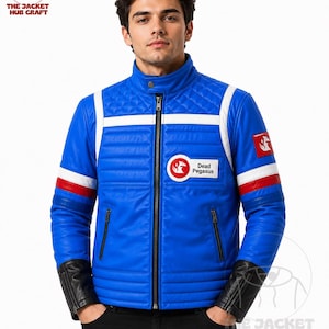 May include: A blue jacket with a stand-up collar, featuring white and red stripes on the sleeves, black cuffs, and a circular patch on the chest that reads Dead Pegasus. The upper chest and shoulders have a quilted texture with a central zipper.