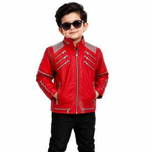 May include: A bright red jacket featuring a high collar, a central silver zipper, and multiple decorative silver zippers across the chest and sleeves. The shoulders are accented with silver studs, and the jacket includes two lower pockets.