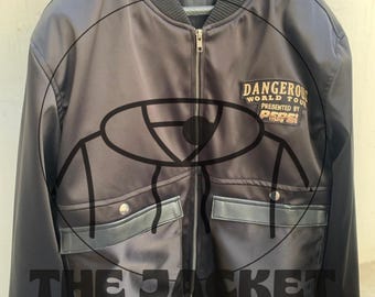 May include: A black bomber jacket with a zip fastening, two front pockets, and a ribbed collar and cuffs. The jacket has a patch that reads "DANGEROUS WORLD TOUR PRESENTED BY PEPSI". The text "THE JACKET HUB CRAFT" is printed on the front.