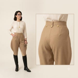 May include: A pair of high-waisted tan breeches featuring a structured waistband with three gold-toned buttons, side pockets, and a flared hip design. The trousers are paired with a cream-colored long-sleeved blouse and black knee-high boots.