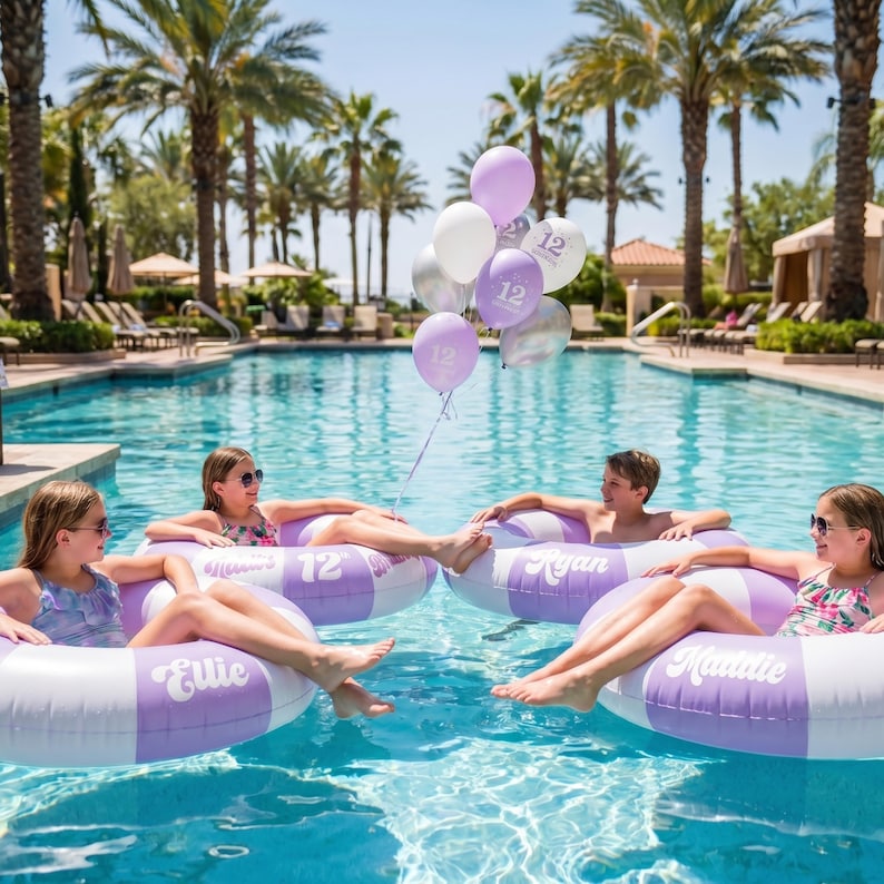 May include: Four children float in a swimming pool on large, round, inflatable pool rings. The rings are white and purple with names printed in white script. A cluster of purple, white, and silver balloons with the number 12 printed on them floats above.