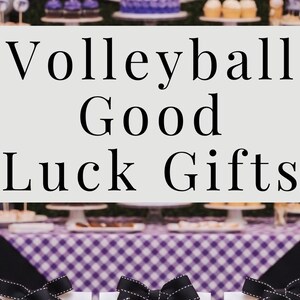 May include: A display of volleyball-themed party decorations and gifts. Includes a scoreboard, balloons, cake, cupcakes, and gift bags with black bows. The text "Volleyball Good Luck Gifts" is visible.