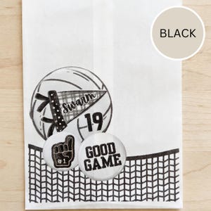 May include: White paper bag with a black and white volleyball graphic, the word "Swarm" on a pennant, and the number 19. Two round buttons read "#1" and "GOOD GAME". A black net design is at the bottom.
