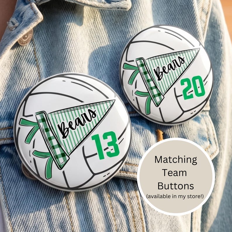 May include: Two white and black volleyball-themed buttons with the word "Bears" on a green pennant. One button has the number 13, the other has 20. The buttons are on a denim jacket.