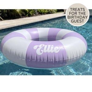 May include: A circular inflatable pool float featuring alternating lavender and white stripes. The name Ellie is printed in white script on one of the lavender sections. A circular badge in the upper right corner displays the text TREATS FOR THE BIRTHDAY GUEST.