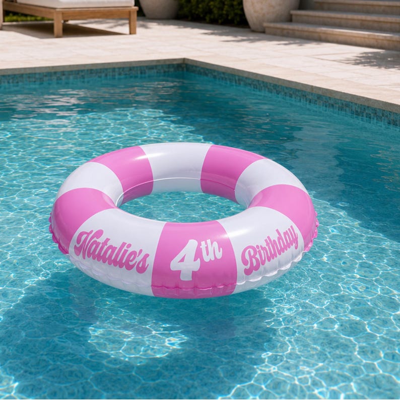 May include: An inflatable circular pool float featuring alternating pink and white segments. The surface is printed with the white text Natalie's 4th Birthday in a stylized font, positioned across the pink and white sections of the ring.