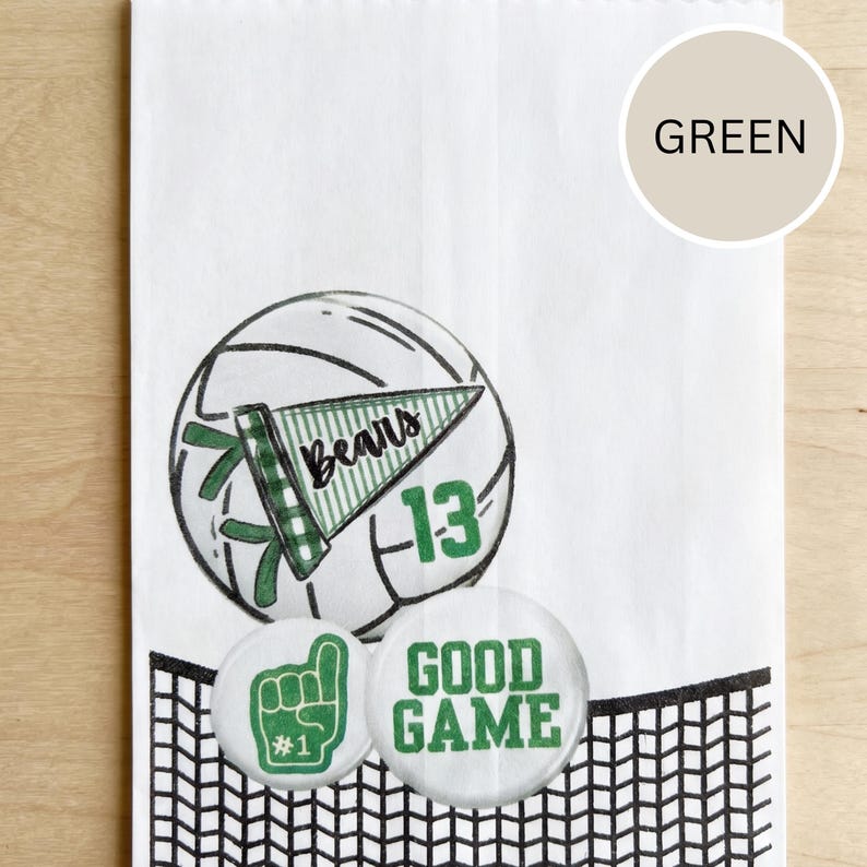 May include: White paper bag with a volleyball graphic, a green pennant that says "Bears" and the number "13". Two round buttons say "Good Game" and "#1". The bag has a black net design at the bottom.