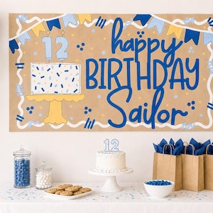 May include: A rectangular brown paper birthday banner featuring blue and yellow bunting, a cake illustration with the number 12, and the text "happy BIRTHDAY Sailor" in blue. The banner is displayed above a table with a cake, cookies, and gift bags.