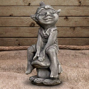 May include: A gray concrete garden statue of a seated gnome with a whimsical expression. The gnome is wearing a tunic and hat, resting his head on his hand while sitting on a mushroom. The statue has a weathered appearance.