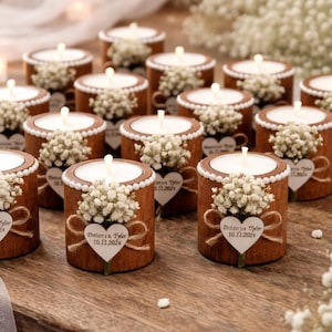 May include: A white ceramic mug with a black handle and the text "But First, Coffee" in a bold, black font. The mug is sitting on a wooden surface. The mug is approximately 4 inches tall.
