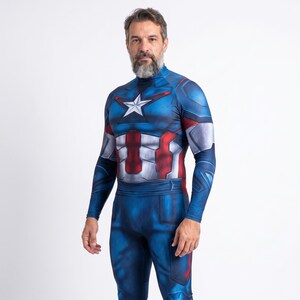 May include: A blue, red, and white Captain America costume with a star on the chest. The long-sleeved bodysuit has a high collar and is worn by a person. The costume is a full body suit.