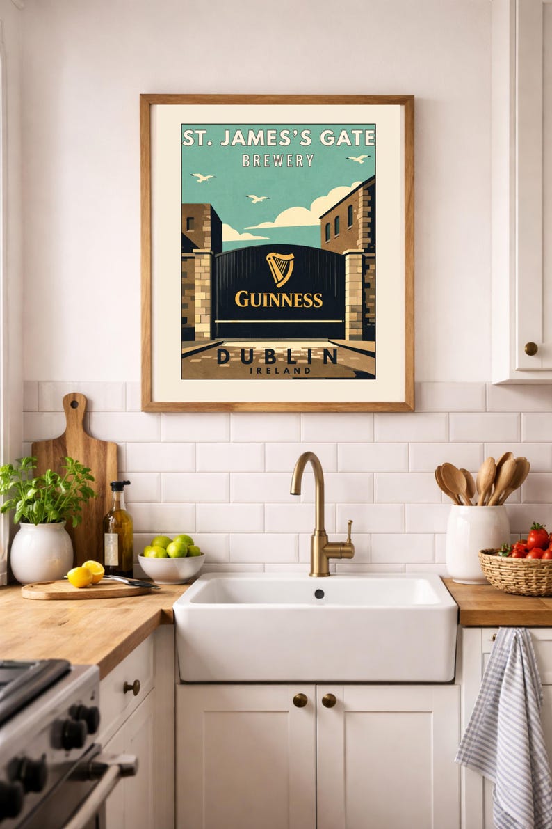 May include: Framed print featuring a vintage-style advertisement for St. James's Gate Brewery in Dublin, Ireland. The artwork showcases the Guinness logo and a gate scene with a blue sky and birds. The print is displayed in a kitchen setting.