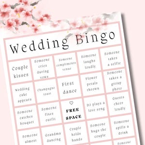Close-up of wedding bingo printable card with pink cherry blossom design and 5x5 bingo grid featuring wedding moments