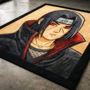 May include: Rectangular rug featuring a detailed illustration of an anime character with black hair, red eyes, and a headband. The character is wearing a black and red outfit. The rug has a black border and a tan background.