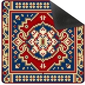 May include: A square rug with a traditional design. The rug features a central pattern in red, blue, and cream colors, surrounded by a border with geometric shapes. The underside is black.