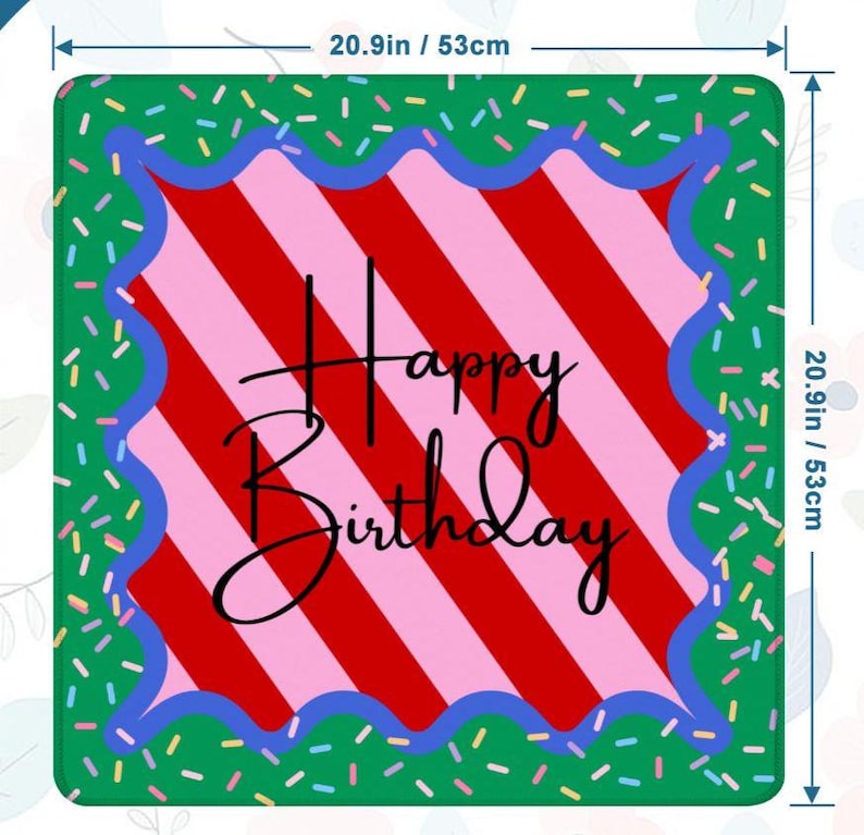 May include: Square birthday mat, 20.9 inches (53cm) on each side. The mat features a red and pink striped center with the words "Happy Birthday" in black script. A blue scalloped border frames the center, set against a green background sprinkled with colorful confetti.