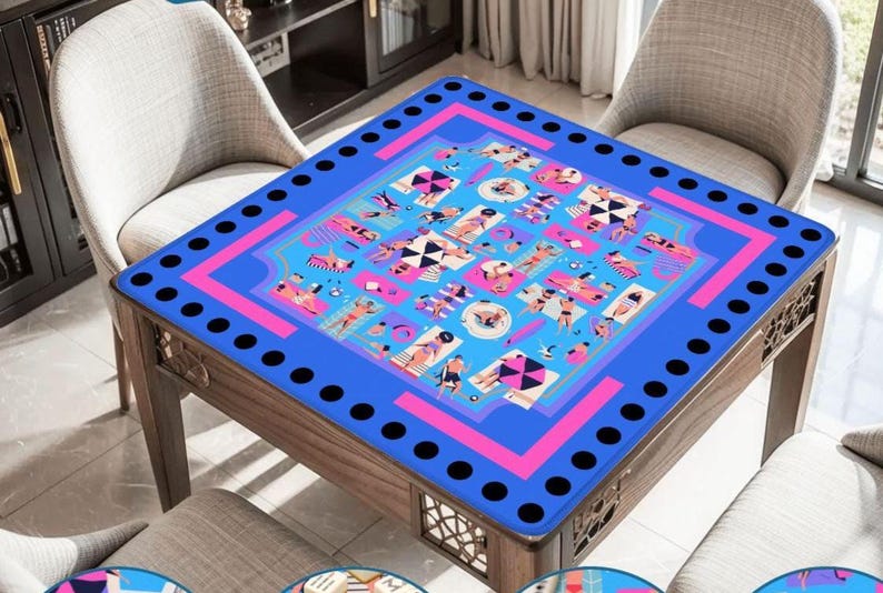 May include: A square wooden table with a blue top featuring a pink and blue beach scene design. The table has a dark wood frame and is surrounded by light gray chairs. The table's top has a border of black circles.