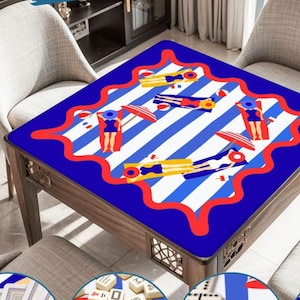 May include: A square wooden table with a blue and white striped top featuring illustrations of people sunbathing with umbrellas. The table's border is a wavy red design. The table is surrounded by chairs.
