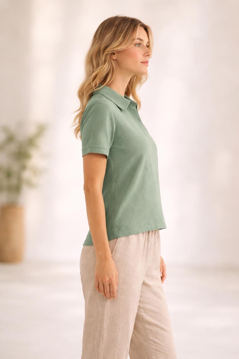 May include: A sage green short-sleeved polo shirt with a classic collar and a buttoned placket, paired with light beige trousers. The shirt features a textured fabric finish and ribbed sleeve cuffs, providing a clean and simple look for daily wear.