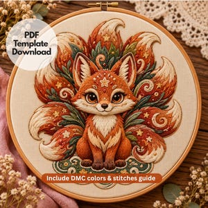 May include: An embroidery hoop containing a fabric panel with a stitched nine-tailed fox design in shades of orange, cream, and green. The fox features star motifs and swirling patterns. Text on the image reads: PDF Template Download and Include DMC colors & stitches guide.