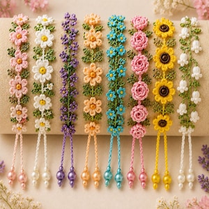 May include: Eight floral bracelets featuring intricate crochet designs of pink, white, purple, orange, blue, and yellow flowers with green leaves. Each bracelet includes two dangling strings finished with matching round beads at the bottom ends.