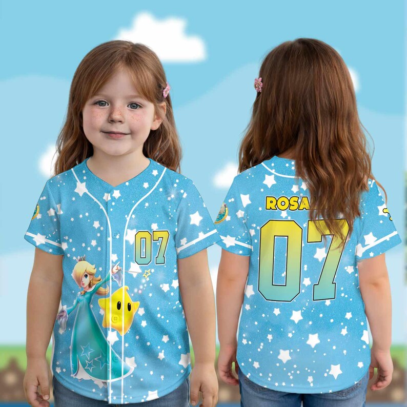 May include: A light blue baseball jersey with white stars and the number 07 in yellow. The front features a cartoon character and a star. The back has the name "ROSA" and the number 07.