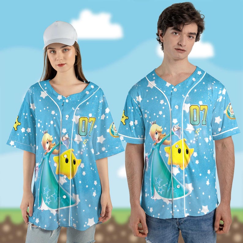 May include: Light blue baseball jersey with a cartoon character design, a star, and the number "07". The jersey has a button-down front and white trim. The background is a light blue sky with white stars.
