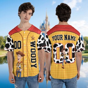 May include: A white ceramic mug with a black handle and the text "But First, Coffee" in a bold, black font. The mug is set against a blurred background, suggesting a cosy setting.