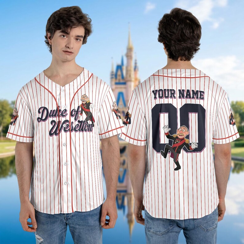 May include: White baseball jersey with red pinstripes, featuring the text "Duke of Weselton" and a cartoon character on the front. The back has "YOUR NAME" above a number and character graphic. Short-sleeved, button-down shirt.