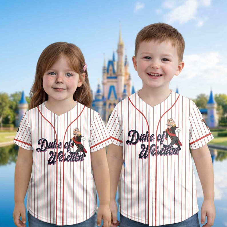 May include: Two children wearing white baseball jerseys with red pinstripes and trim. The jerseys feature the text "Duke of Weselton" and a cartoon image. The background shows a castle.