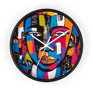 May include: A colorful abstract clock face with a black frame. The face features a stylized portrait of a person with a blue, pink, orange, yellow, and green color scheme.