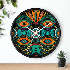 May include: A round wall clock with a black frame and a colorful, abstract design featuring eyes, circles, and geometric patterns in shades of green, orange, blue, and yellow.