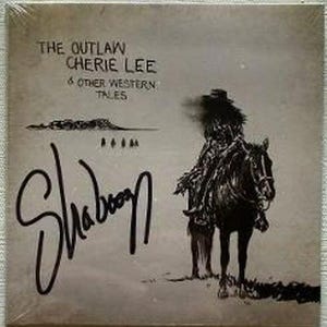 May include: A square vinyl record cover in a muted beige tone featuring a black ink illustration of a person in a cowboy hat riding a horse. The text reads THE OUTLAW CHERIE LEE & OTHER WESTERN TALES with a large black handwritten signature Shaboo.