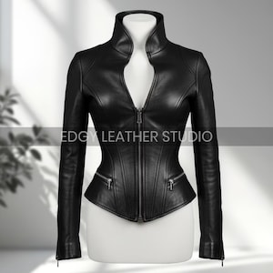 May include: A black leather jacket with a high collar and a zipper closure. The jacket has a fitted silhouette with two zippered pockets and the text "EDGY LEATHER STUDIO".