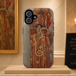 May include: A smartphone case featuring a reproduction of Gustav Klimt's Water Serpents II painting. The design displays a figure with flowing red hair, intricate gold patterns, and a winding serpent against a muted gray background with red accents.