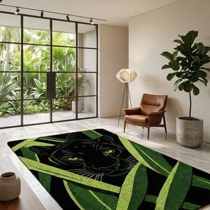 May include: Black and green area rug featuring a panther's face surrounded by green leaves. The rug has a rectangular shape and is placed on a light-colored floor. The room has large windows and a modern design.