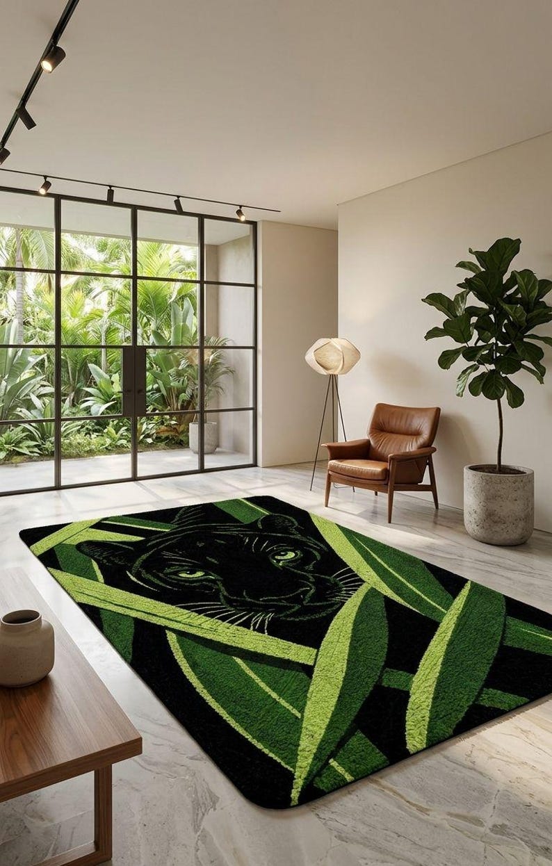 May include: Black and green area rug featuring a panther's face surrounded by green leaves. The rug has a rectangular shape and is placed on a light-colored floor. The room has large windows and a modern design.