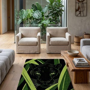 May include: A black rug featuring a panther's face peering through green leaves. The rug has a black background and a green and black leaf design. The rug is in a living room with neutral-toned furniture and hardwood floors.